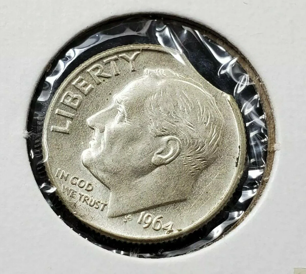 1964 dime clipped planchet error showing curved notch missing from coin edge beside normal dime